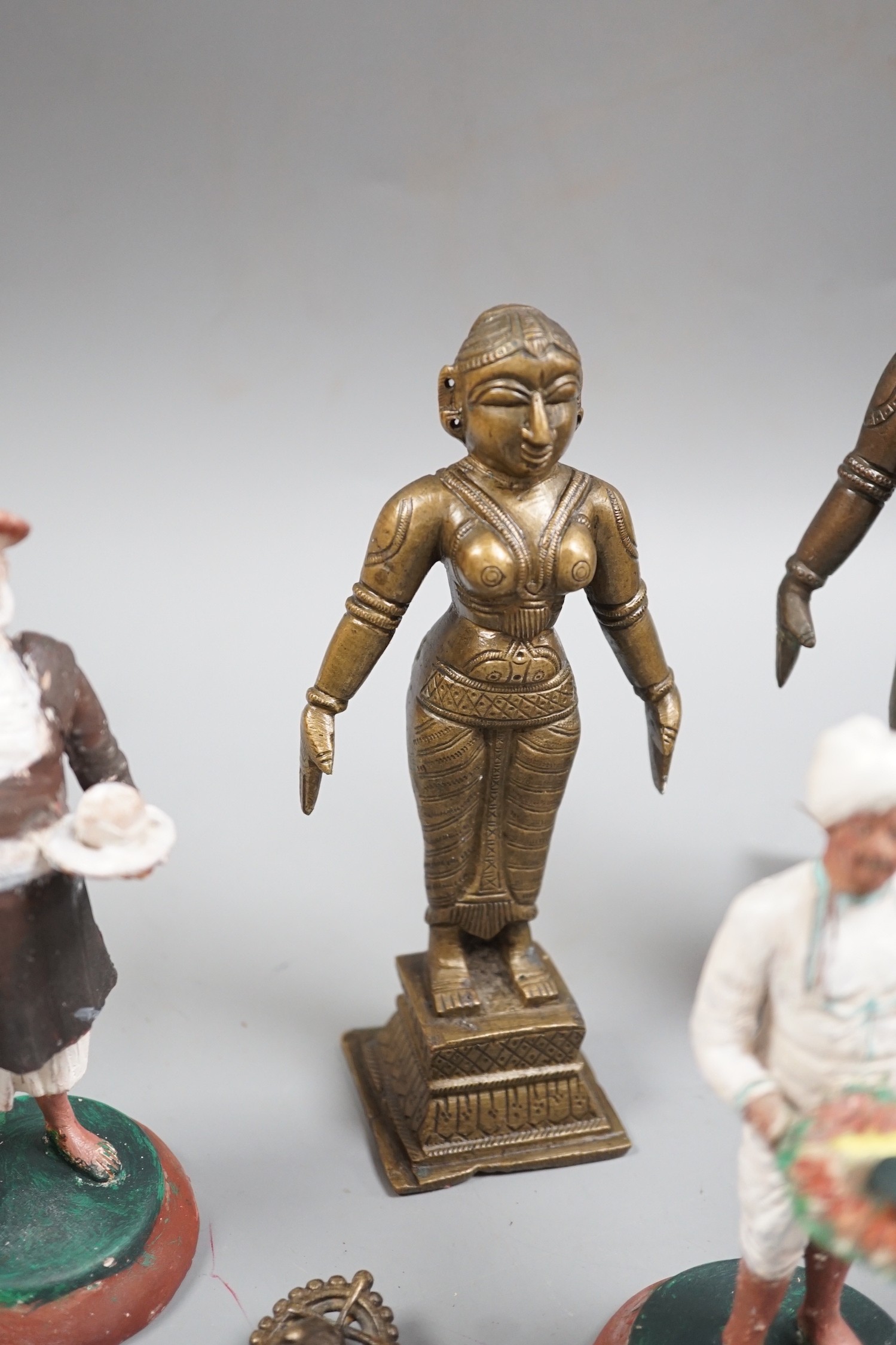 A group of Indian bronze figures of deities, tallest 20 cm and three Indian painted clay figures